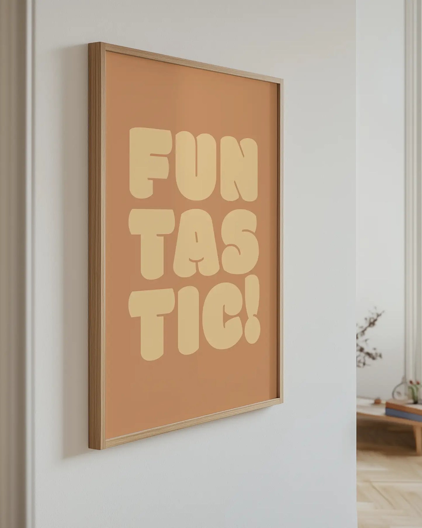 Framed artwork with 'FUN TASTIC!' text on a wall.