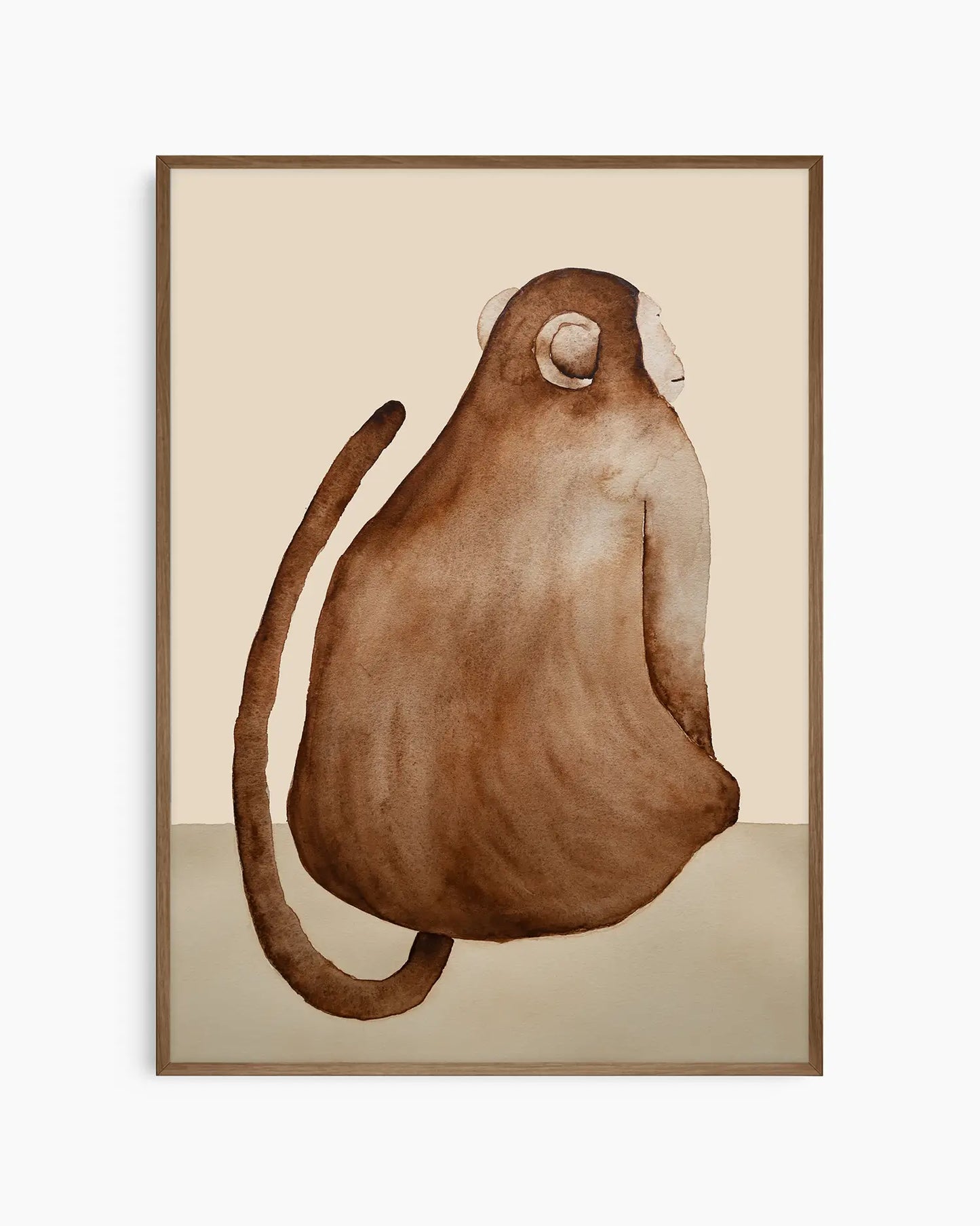 Nursery poster of a brown monkey on a beige background inside of a dark oak frame.