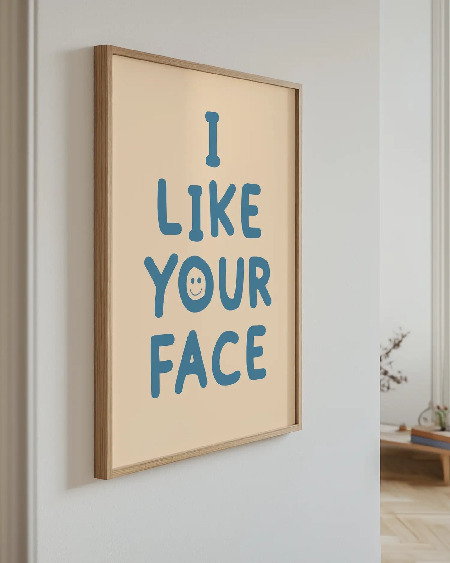 Artwork with 'I LIKE YOUR FACE' text on a wall.