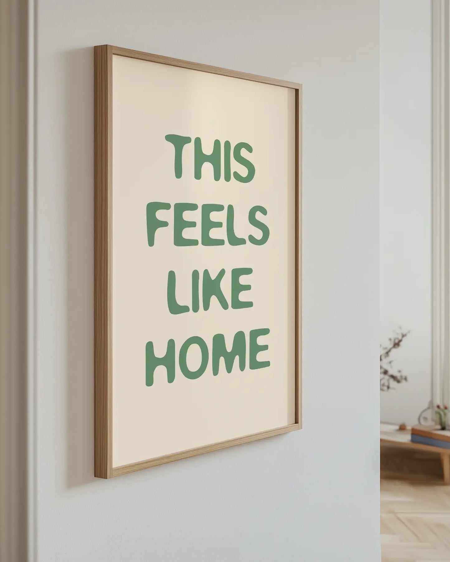 Artwork with green 'This Feels Like Home' text on a wall.