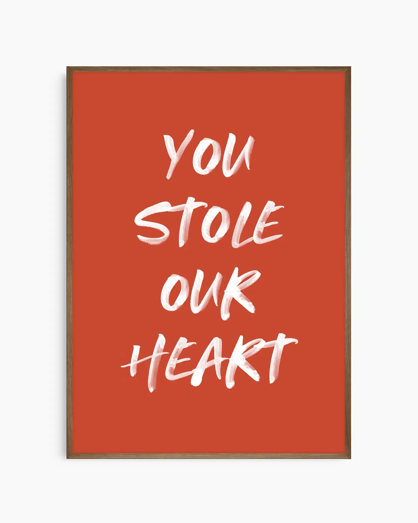 Nursery poster with white text 'You stole our heart' on a red background. Dark oak frame.