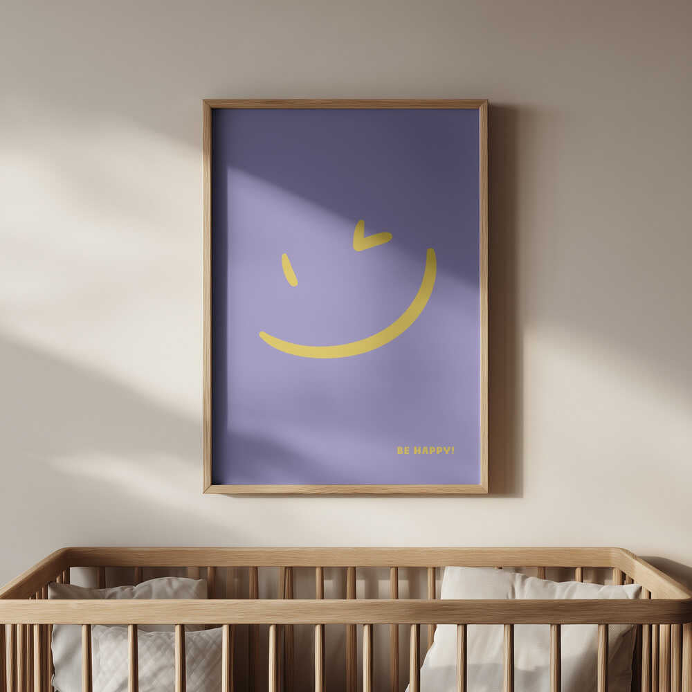 Framed poster with a yellow smiley on a purple background and the text 'Be happy!' written on it. Hanging on the wall above the baby crib.