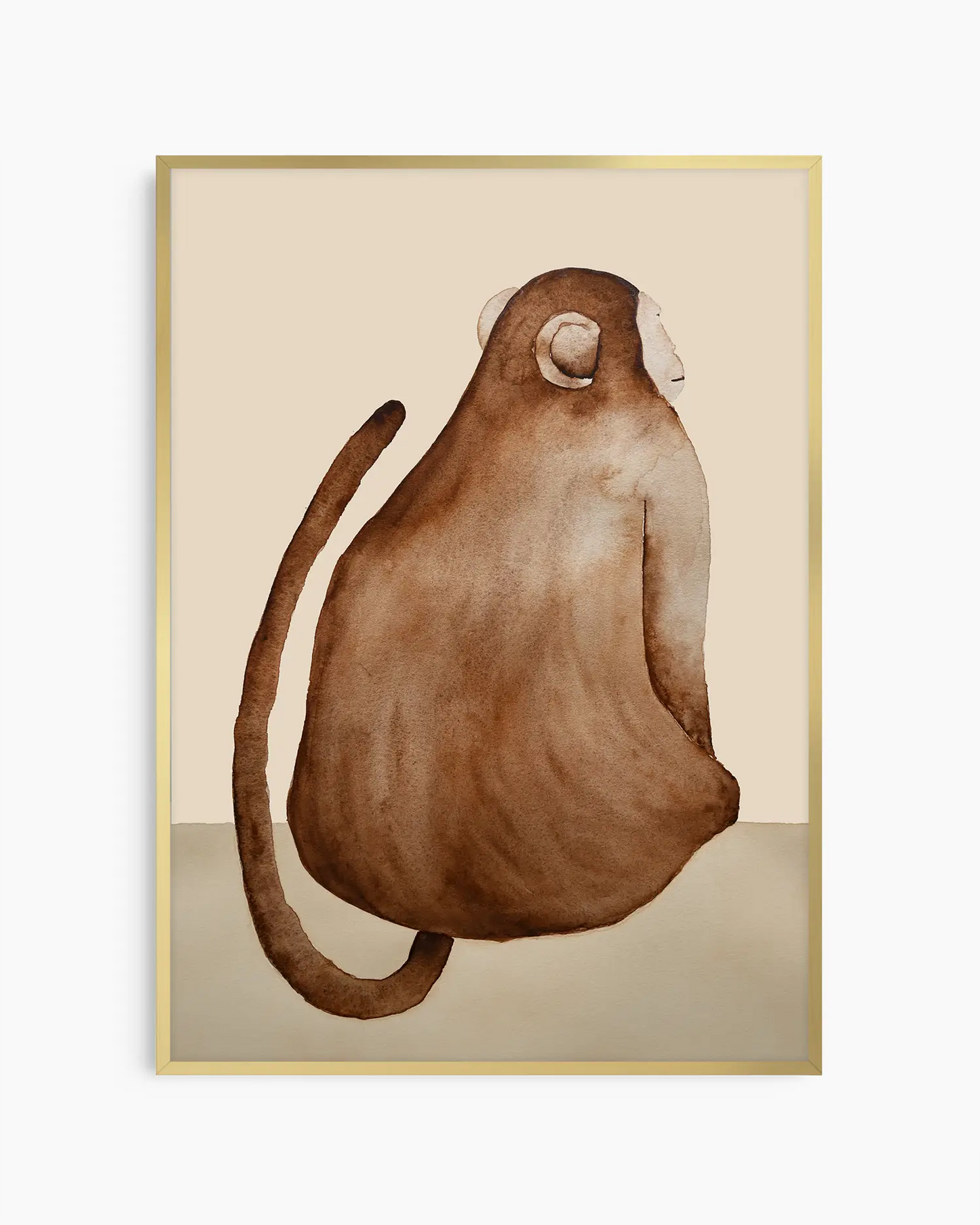 Nursery poster of a brown monkey on a beige background inside of a gold aluminium frame.