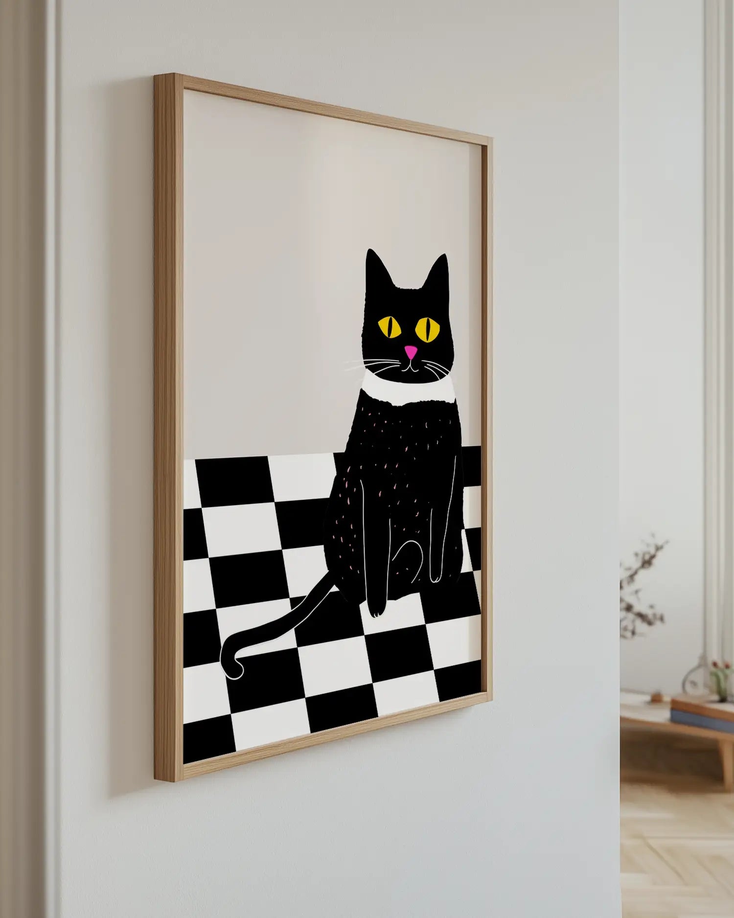 Artwork of a black cat on a checkered background in a room.