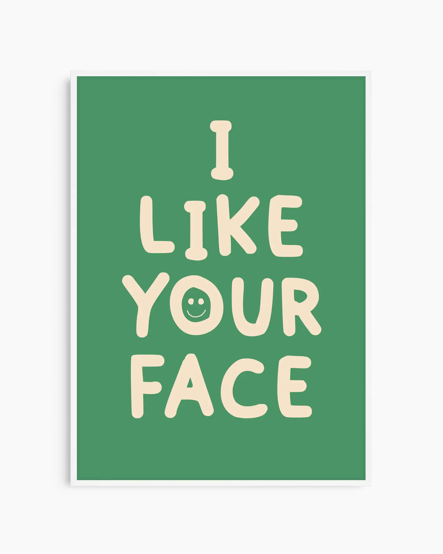 Green nursery poster with the text 'I like your face' written in beige, framed in a white frame.