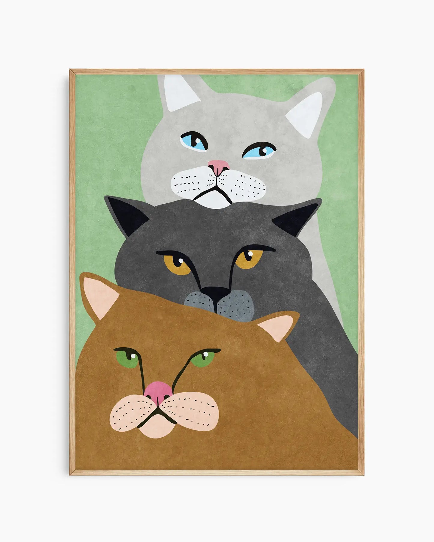Framed artwork of three cats with different colored faces on a green background