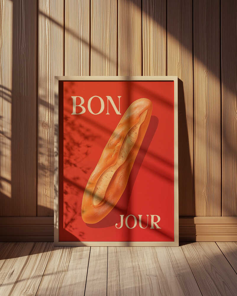 Framed poster with a baguette on a red background and the text 'BONJOUR' leaning against a wooden wall.
