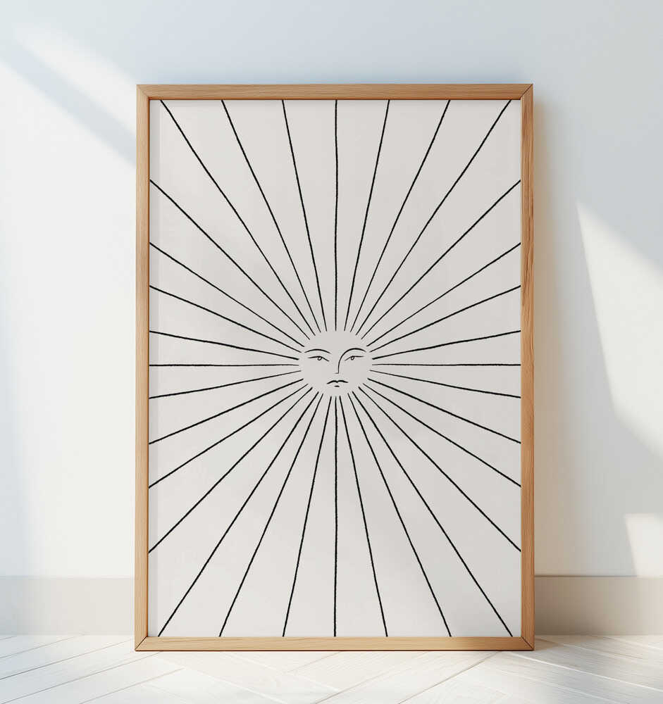 Modern sun line art poster in monochrome, showing a serene sun face with radiant lines. Framed in light wood and leaning against a white wall — a simple yet elegant statement piece for a calm, minimal home decor style.
