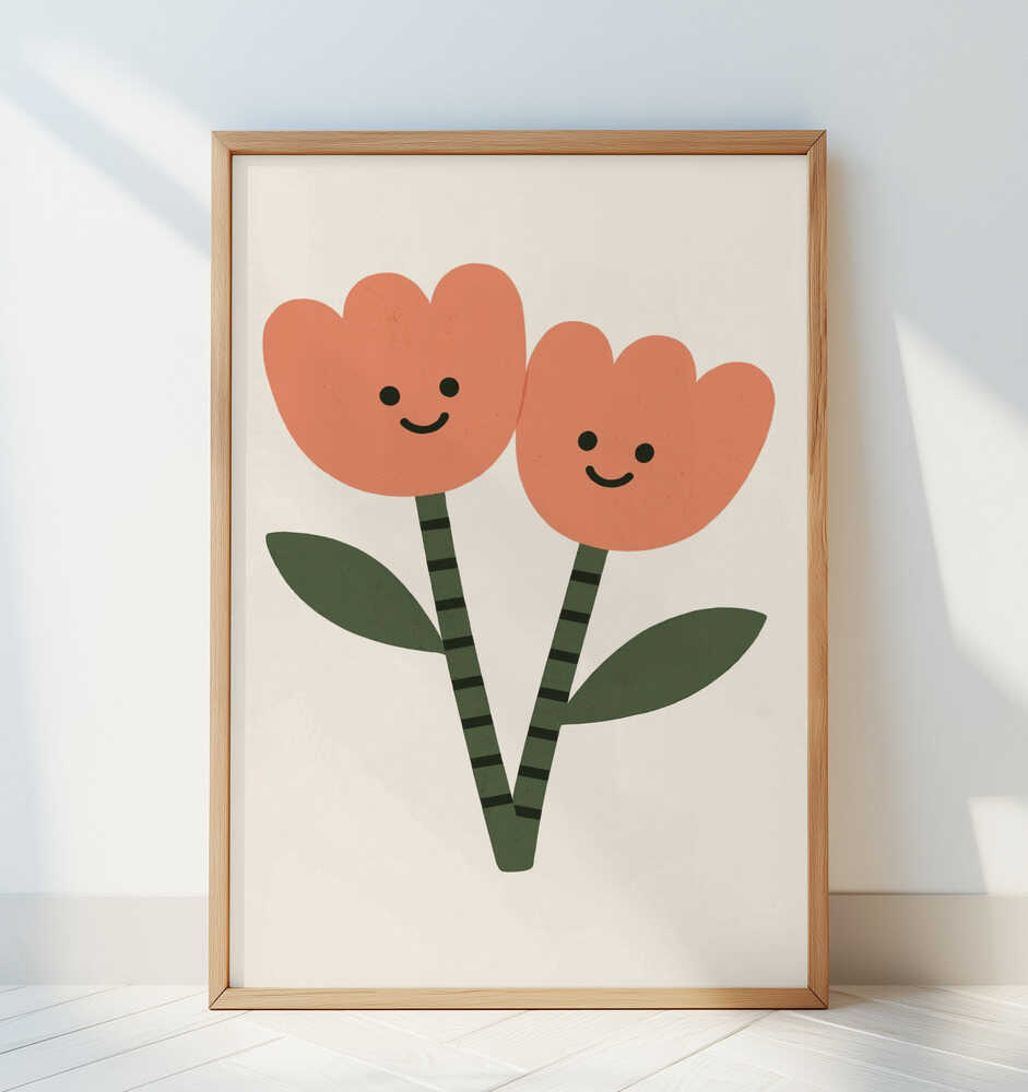 Framed nursery poster with two happy flowers on a white background. Leaning against a white wall.